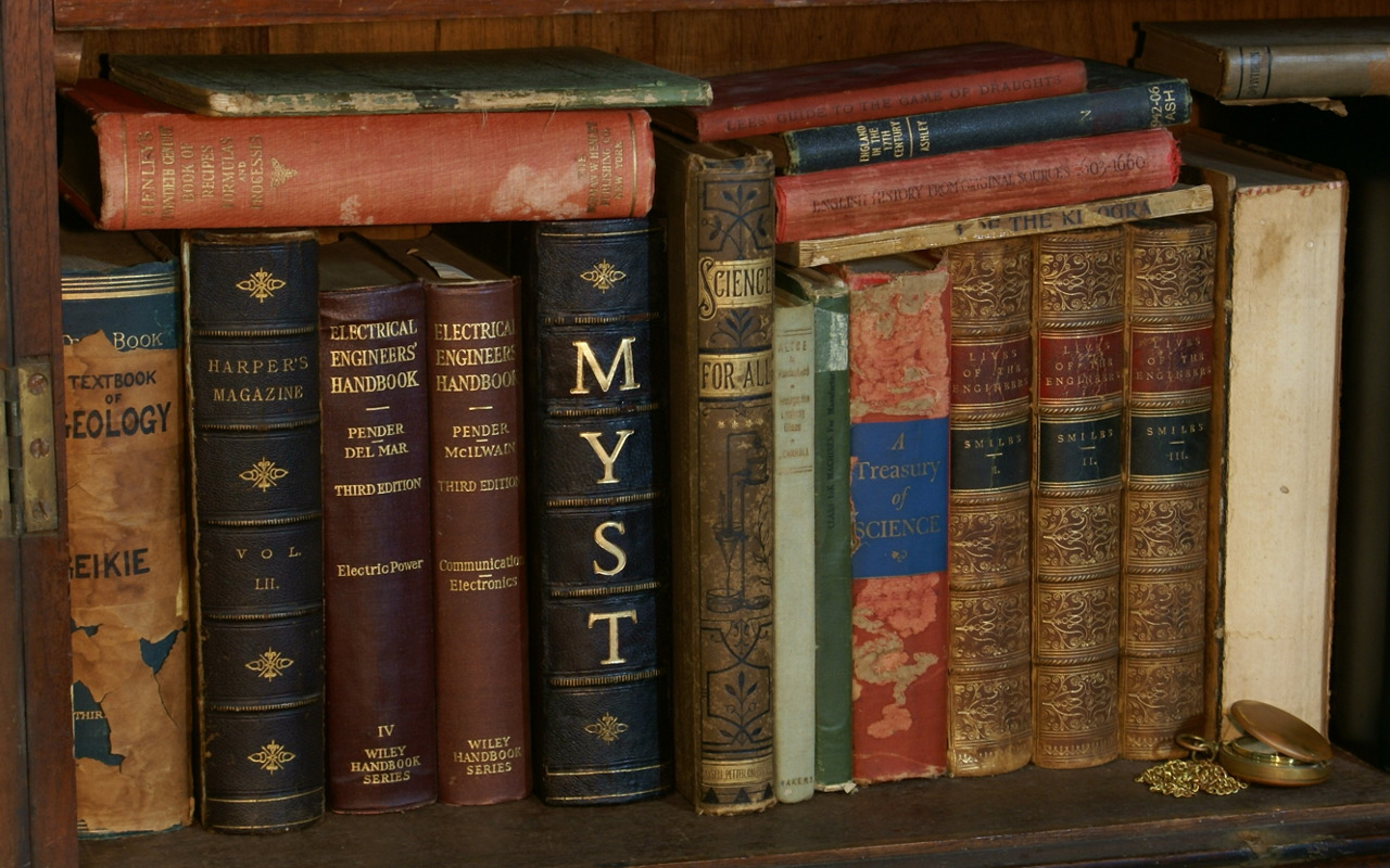 Old books on a bookshelf, including the Myst book