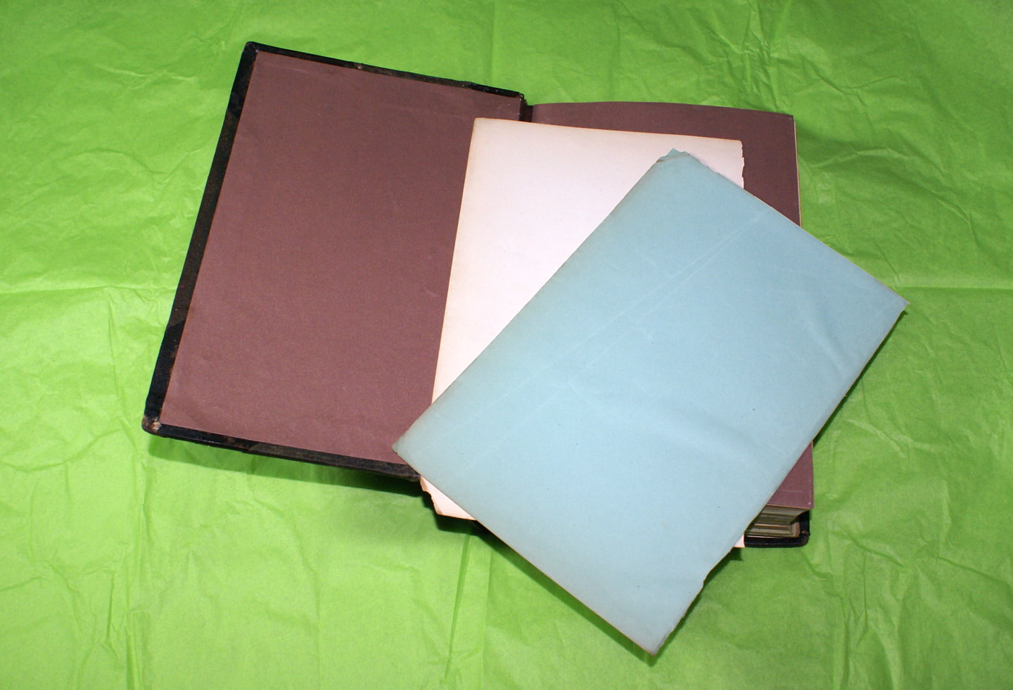 A white page, blue page, and red interior cover of the book